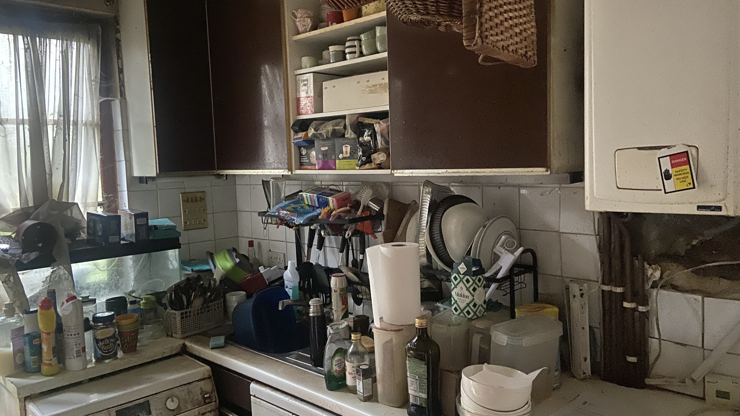 Professional clearance team working inside a heavily cluttered property